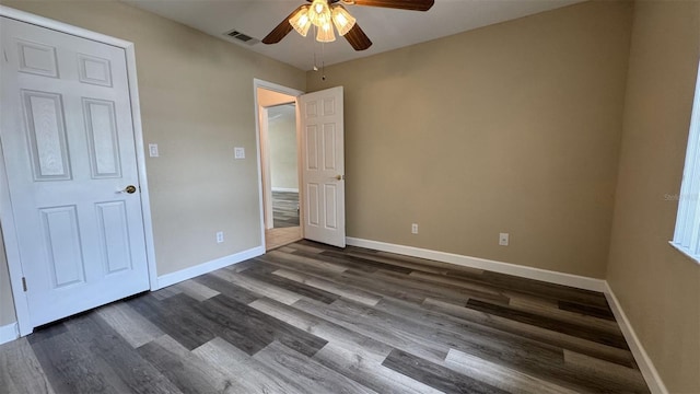 unfurnished bedroom featuring dark hardwood / wood-style flooring and ceiling fan