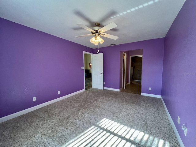 unfurnished bedroom featuring ceiling fan, carpet, and ensuite bath