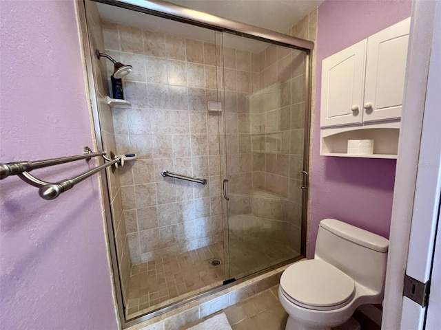 bathroom with an enclosed shower and toilet