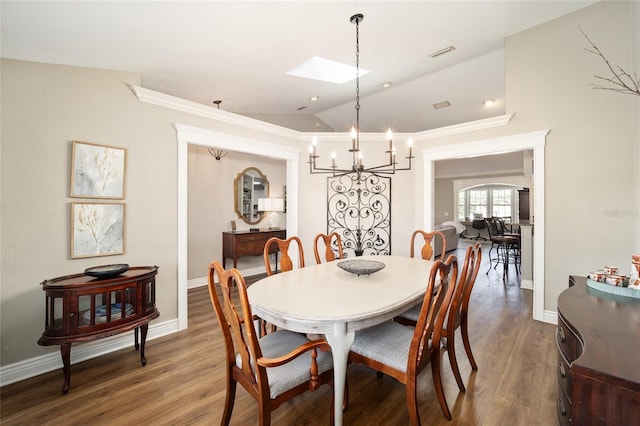 dining area with lofted ceiling, wood finished floors, visible vents, and baseboards