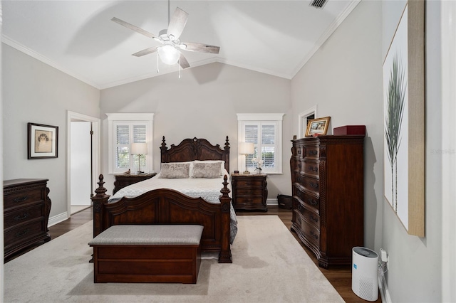 bedroom featuring ornamental molding, vaulted ceiling, ceiling fan, wood finished floors, and baseboards