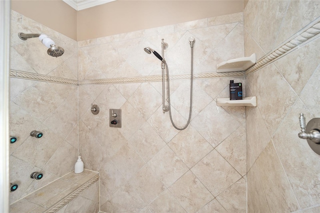 bathroom with ornamental molding and tiled shower