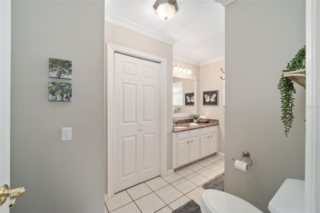 bathroom featuring toilet, tile patterned flooring, ornamental molding, and vanity