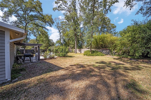 view of yard featuring fence and a patio