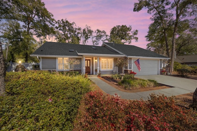 ranch-style house featuring driveway and a garage