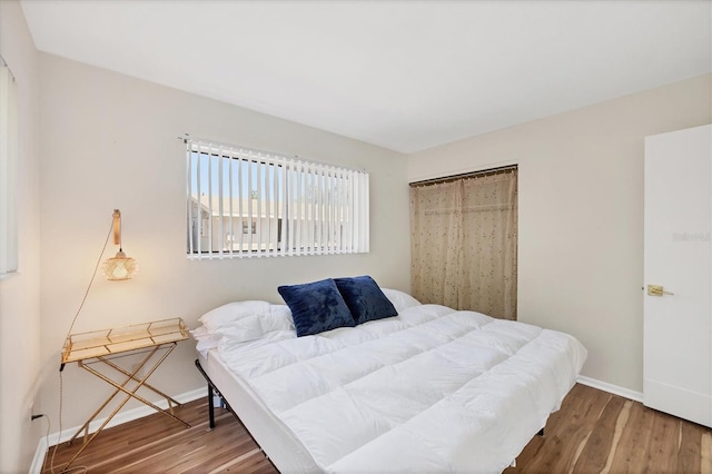 bedroom with hardwood / wood-style floors