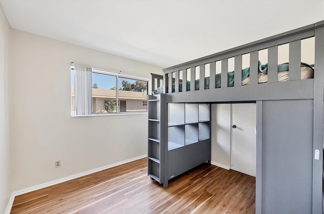 unfurnished bedroom with hardwood / wood-style floors