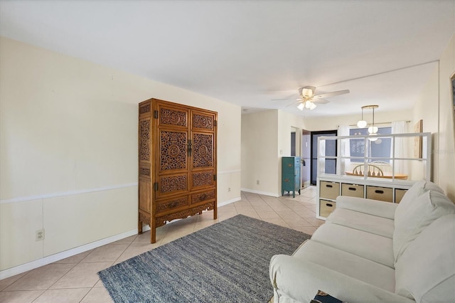 tiled living room featuring ceiling fan