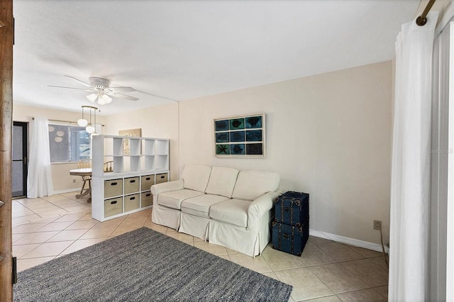 tiled living room with ceiling fan