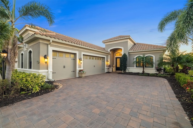 mediterranean / spanish-style home featuring a garage