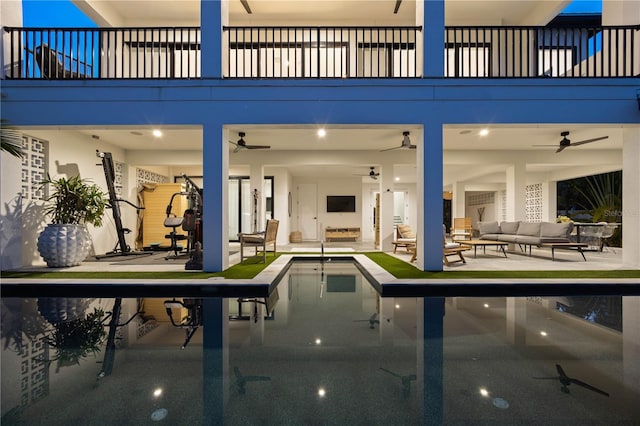 view of swimming pool featuring ceiling fan, outdoor lounge area, and a patio area