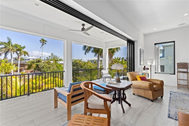 sunroom featuring ceiling fan