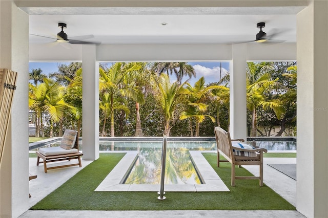 unfurnished sunroom with ceiling fan