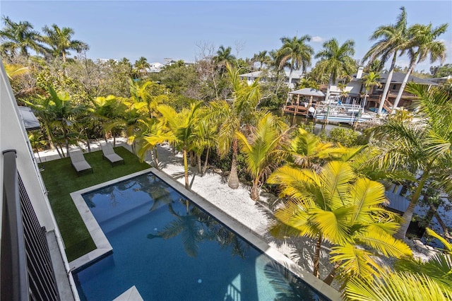 view of pool featuring a lawn