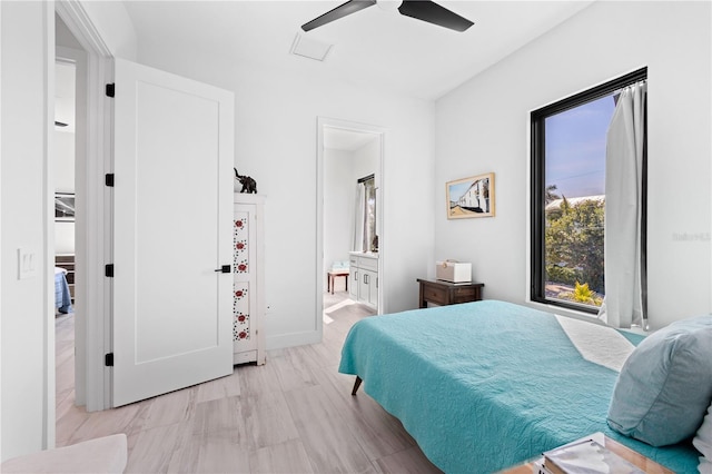 bedroom with ensuite bathroom, ceiling fan, and light hardwood / wood-style floors