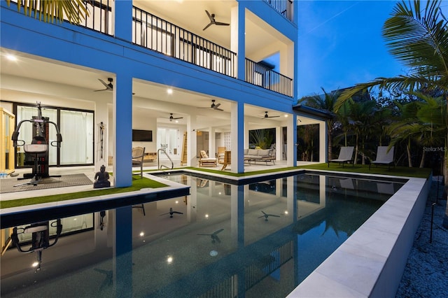 view of pool featuring outdoor lounge area, a patio, and ceiling fan