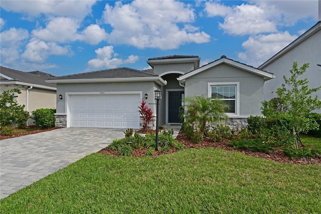 view of front facade with a garage and a front lawn