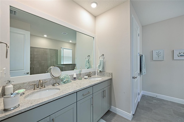 bathroom featuring vanity and a shower