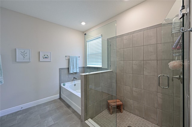 bathroom featuring independent shower and bath