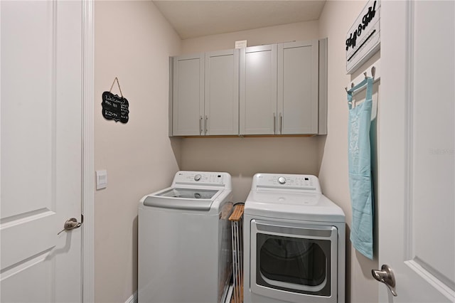 laundry area featuring cabinets and washer and dryer