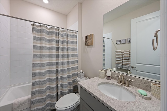 full bathroom with vanity, shower / tub combo, and toilet