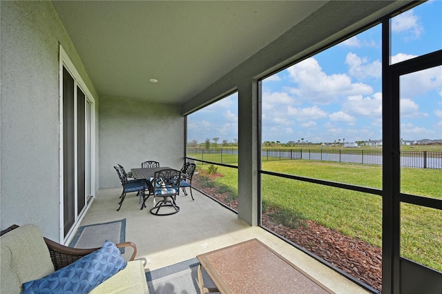 sunroom with a water view