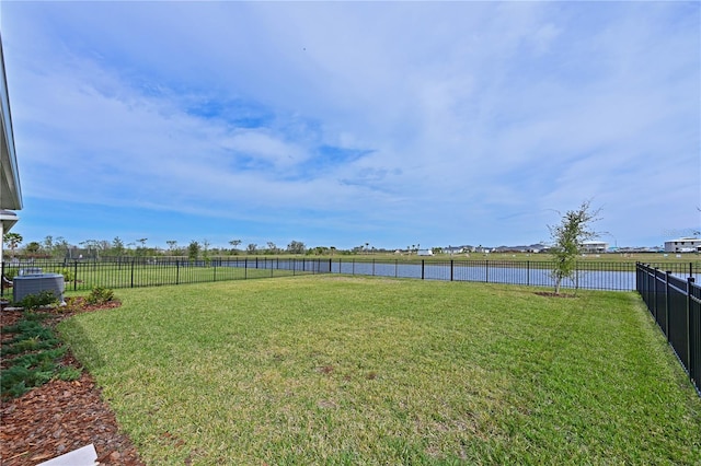 view of yard featuring a water view and central air condition unit