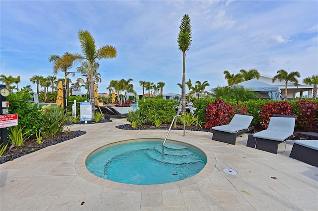 view of pool with a community hot tub and a patio