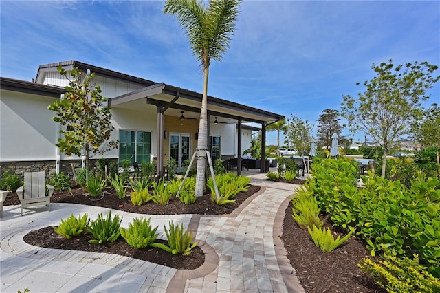 exterior space with ceiling fan