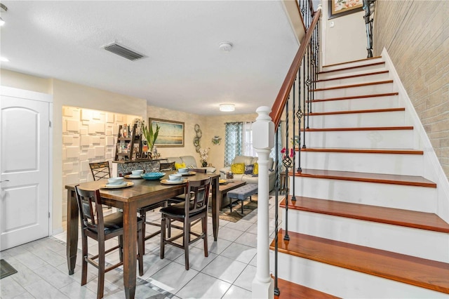 dining space featuring light tile patterned floors