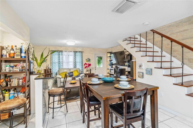 dining space featuring light tile patterned floors