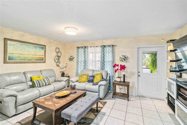 living room featuring a wealth of natural light and light tile patterned floors