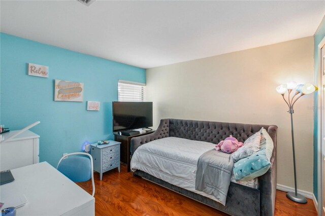 bedroom featuring dark hardwood / wood-style flooring