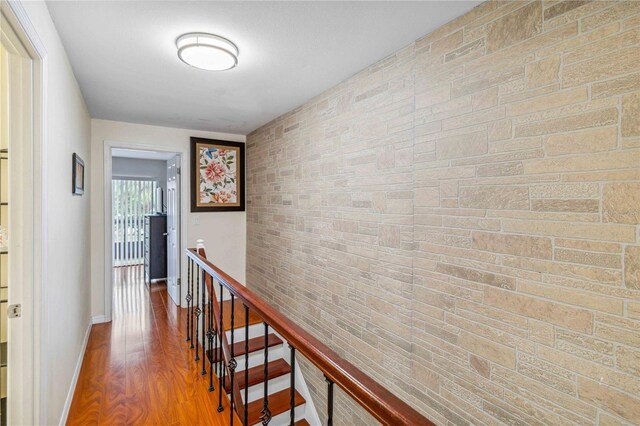 hallway with hardwood / wood-style floors