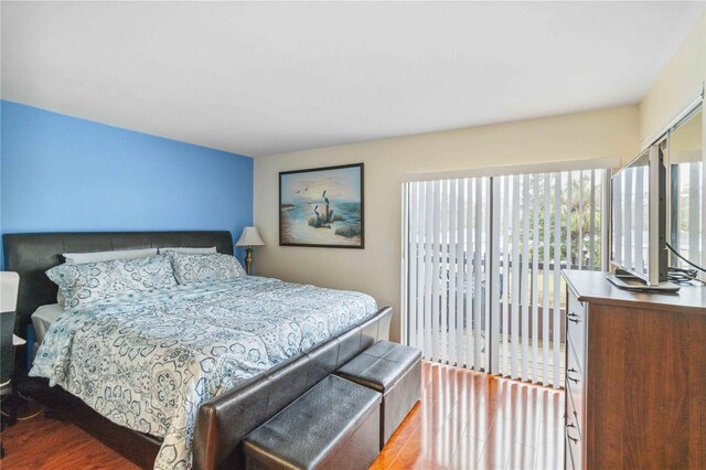 bedroom featuring hardwood / wood-style flooring and access to outside