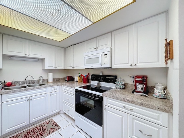 kitchen with electric stove, white cabinetry, sink, and light tile patterned floors