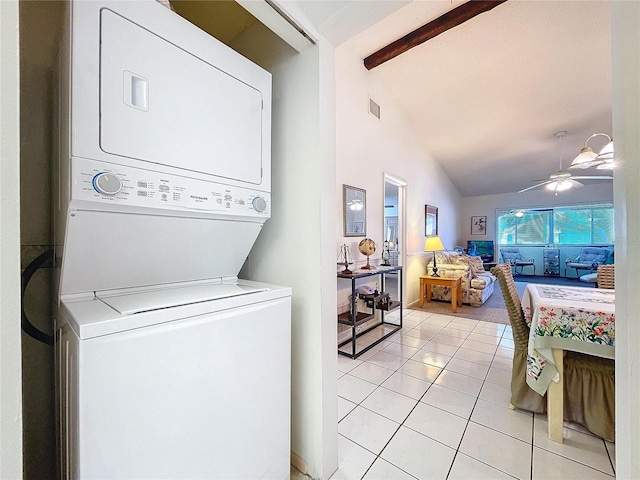 clothes washing area featuring stacked washer and clothes dryer, light tile patterned floors, and ceiling fan