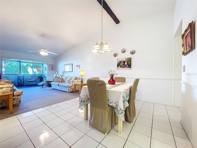 tiled dining area with ceiling fan with notable chandelier and high vaulted ceiling