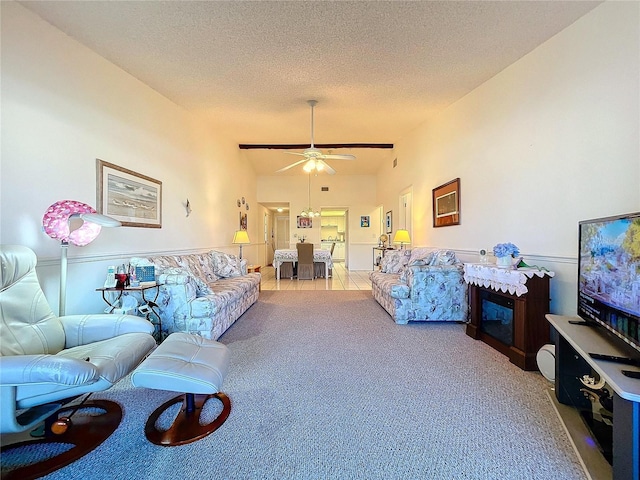 living room with ceiling fan, vaulted ceiling, light carpet, and a textured ceiling