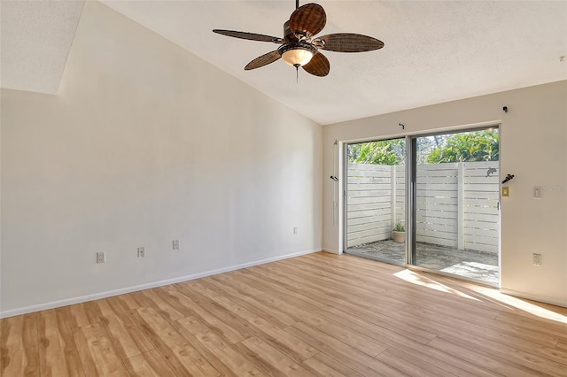 unfurnished room with ceiling fan, vaulted ceiling, a textured ceiling, and light wood-type flooring