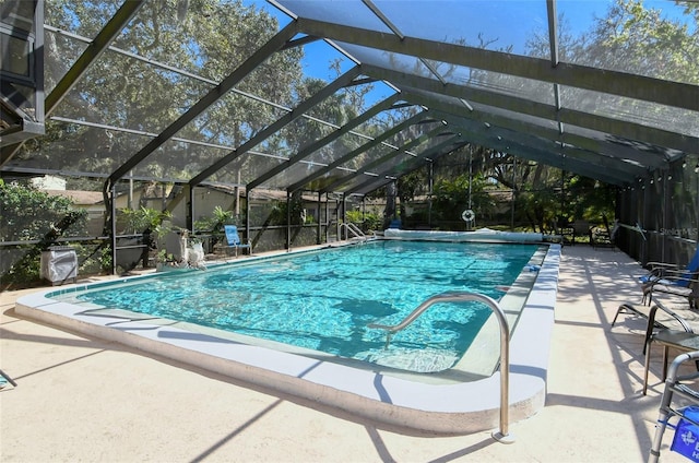 view of pool with a patio and glass enclosure