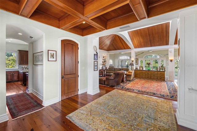 16475 Captiva Dr, Captiva, FL 33924 - entryway featuring arched walkways, baseboards, coffered ceiling, plenty of natural light, and wood ceiling with exposed beams