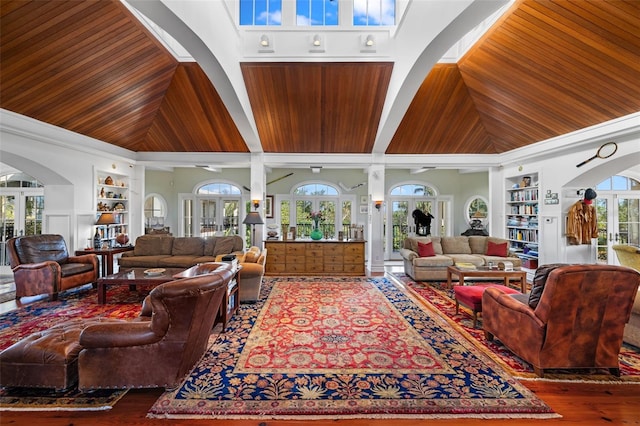 16475 Captiva Dr, Captiva, FL 33924 - living room featuring built in features, wooden ceiling, high vaulted ceiling, arched walkways, and wood finished floors