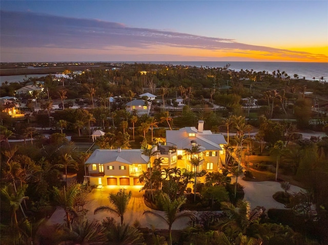 aerial view at dusk with a water view