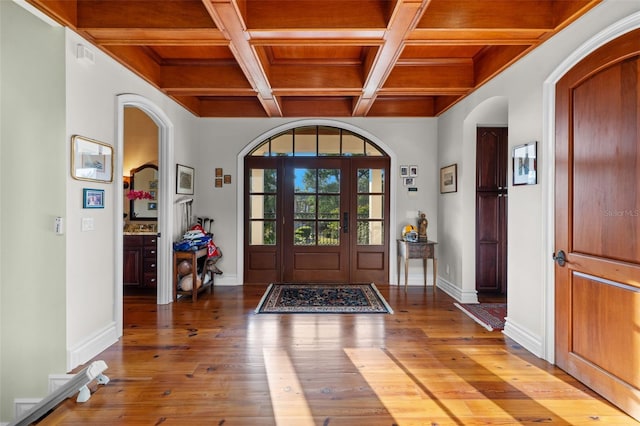 16475 Captiva Dr, Captiva, FL 33924 - foyer with wood ceiling with exposed beams, arched walkways, wood-type flooring, coffered ceiling, and baseboards