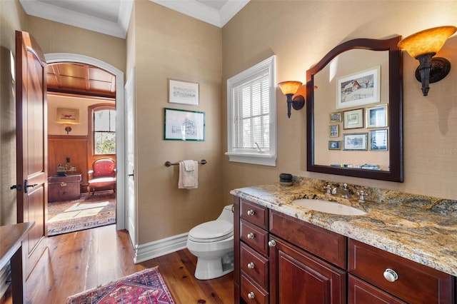 16475 Captiva Dr, Captiva, FL 33924 - bathroom with vanity, wood finished floors, toilet, crown molding, and baseboards