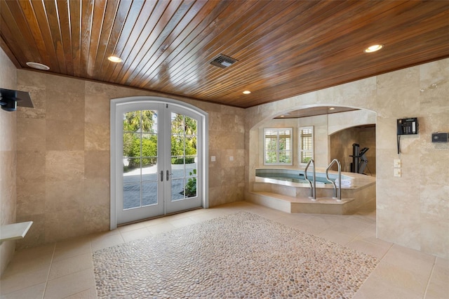 16475 Captiva Dr, Captiva, FL 33924 - bathroom featuring french doors, wooden ceiling, tile patterned flooring, tile walls, and recessed lighting