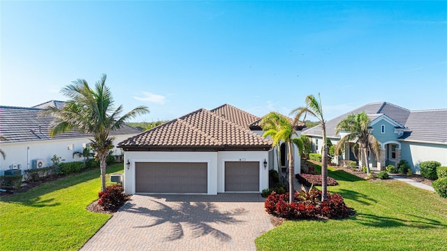 view of front of home featuring a garage and a front lawn