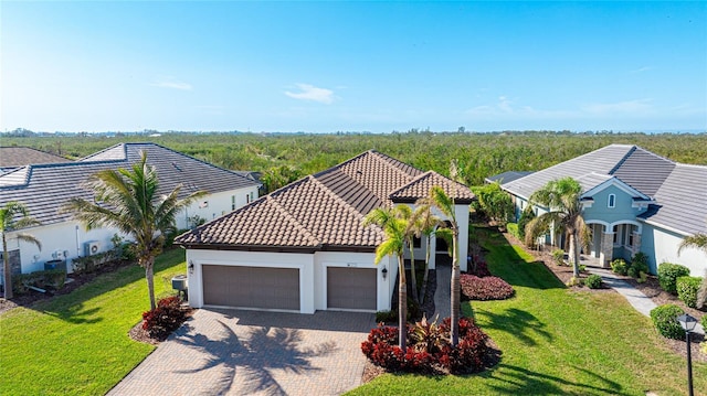 view of front of property with a garage and a front lawn