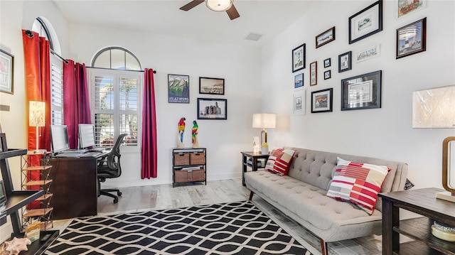 living room featuring light hardwood / wood-style floors and ceiling fan